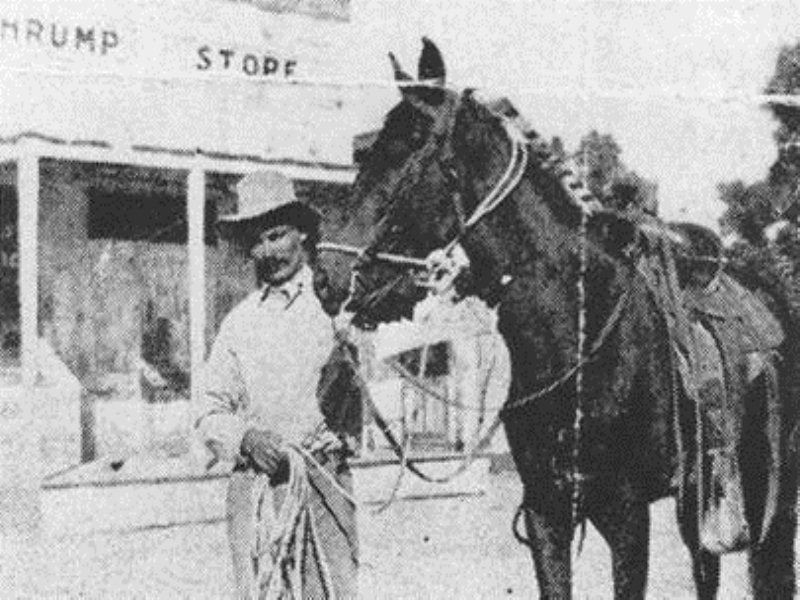 A rider and horse in front of the Pahrump store